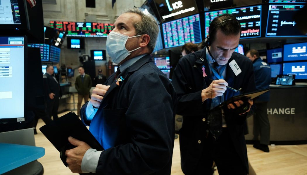 Dow sinks 1,800 as virus cases rise, deflating optimism