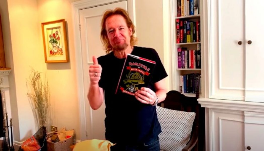 IRON MAIDEN’s ADRIAN SMITH Unboxes First Copy Of His Upcoming Fishing Memoir ‘Monsters Of River & Rock’