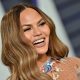 Chrissy Teigen Channels Cher’s ’90s Workout Videos For ‘The Best 38 Minutes of Fat-Burning Fun’