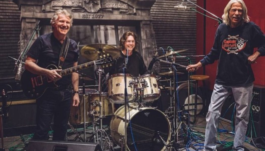 TRIUMPH’s RIK EMMETT Says Upcoming Documentary Will Feature ‘A Little Bit More’ Of GIL MOORE’s Perspective Than His Own