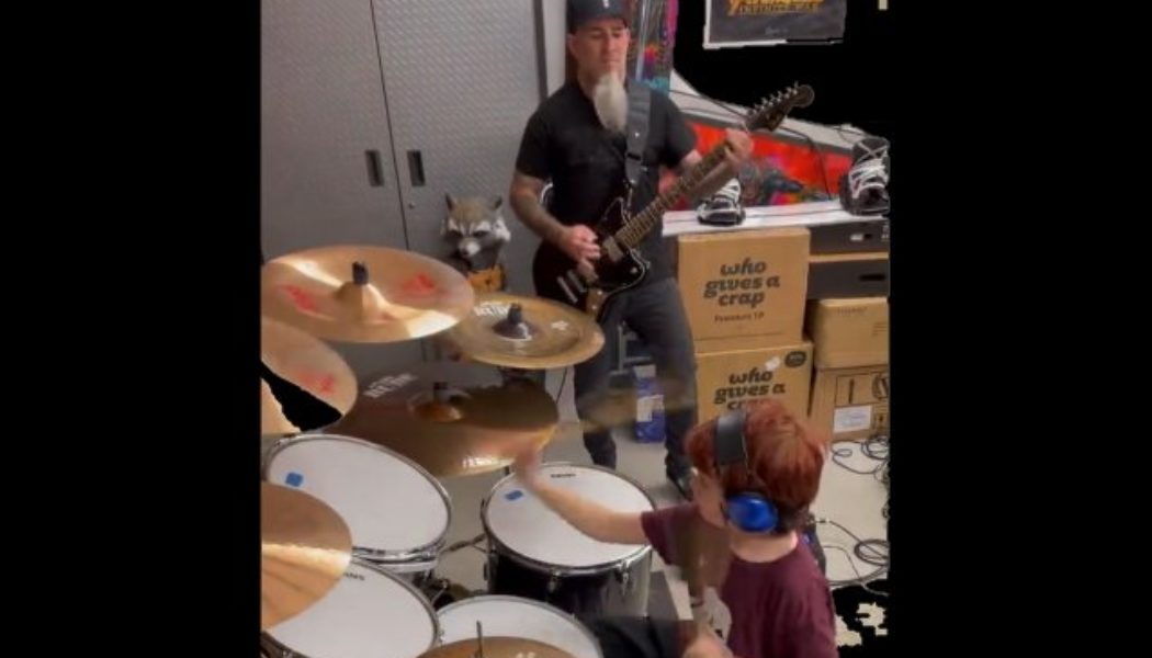 Watch ANTHRAX’s SCOTT IAN Play KORN’s ‘Here To Stay’ With His 10-Year-Old Son