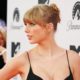 Taylor Swift Pairs a Plunging Bodysuit With a See-Through Skirt at the MTV EMAs