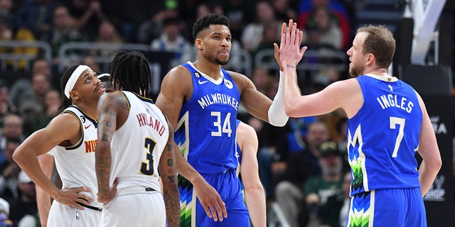 Milwaukee Bucks forward Giannis Antetokounmpo (34) high-fives guard Joe Ingles during the second half at Fiserv Forum, Jan 25, 2023, in Milwaukee.