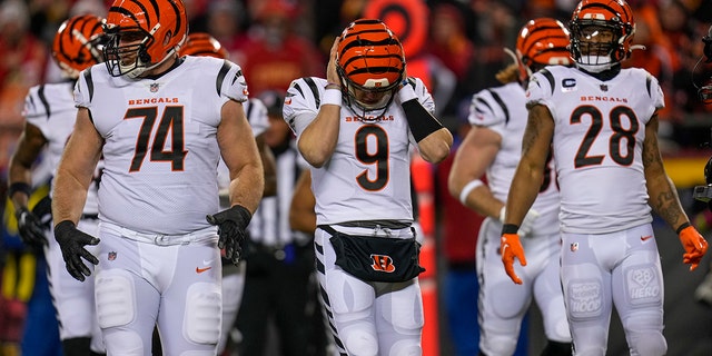 Cincinnati Bengals quarterback Joe Burrow covers his ears to receive a play during the AFC Championship Game, Sunday, Jan. 29, 2023, at Arrowhead Stadium in Kansas City, Missouri.