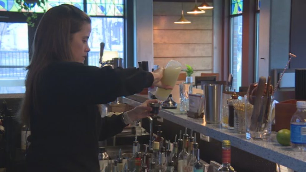 Blind Shot Social Club owner Michelle Duvall creates a mocktail at her east Madison bar.