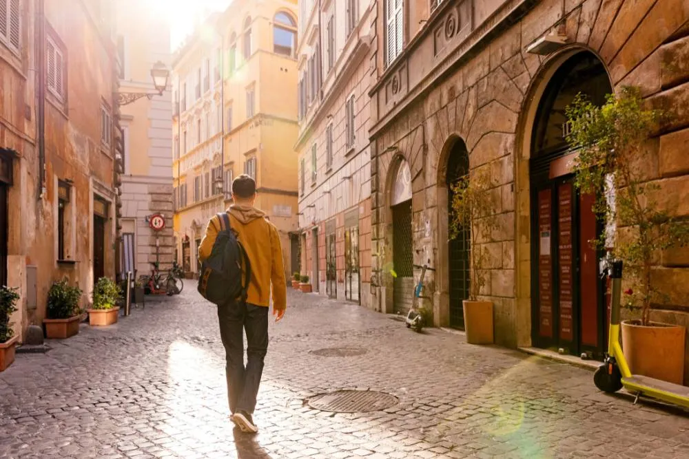 Solo tourist walking down side street in Rome — Getty Images