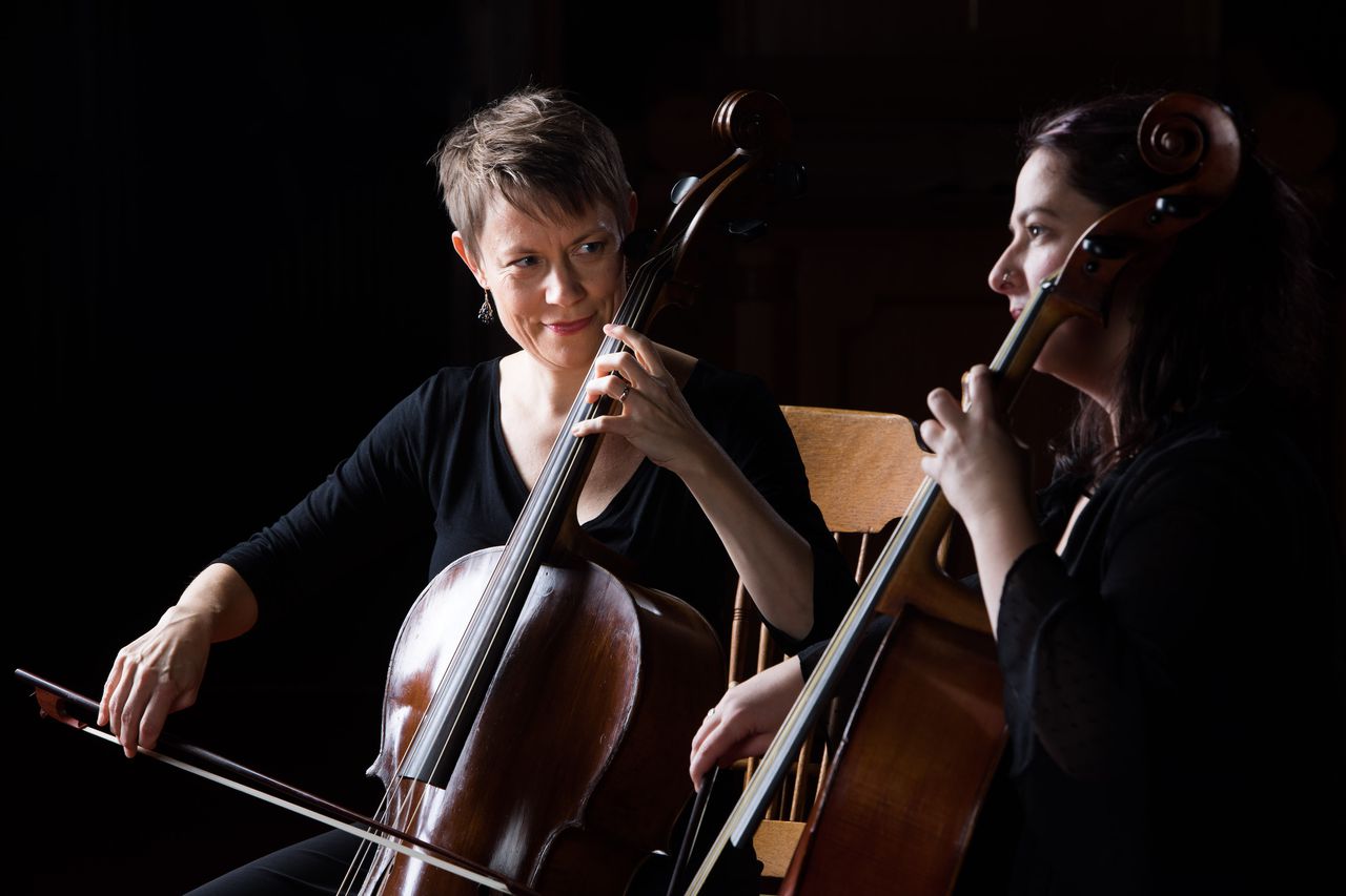 Two women play their cellos