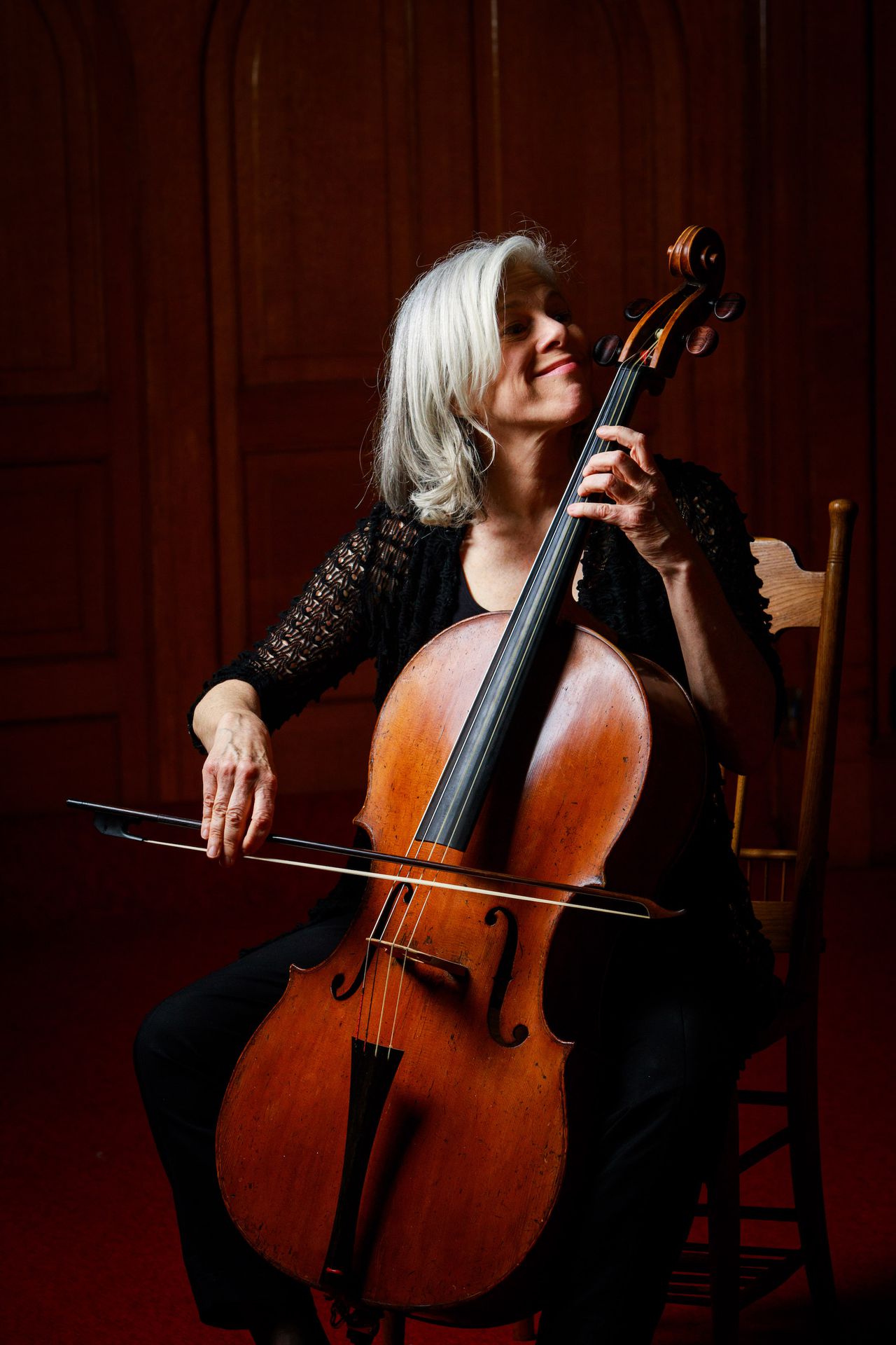 A woman plays a cello.