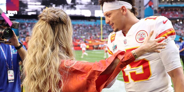 Brittany and Patrick Mahomes embrace on the field before Super Bowl LVII at State Farm Stadium in Glendale, Arizona, on Sunday.