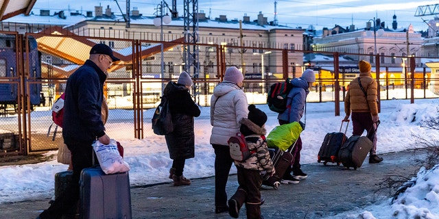 A family arrive at the railway station in Przemysl, Poland from Ukraine on December 20, 2022. 