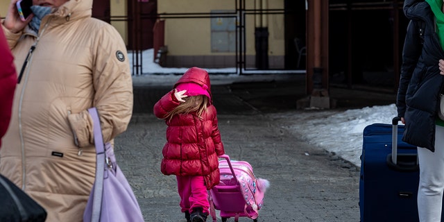 A family arrive at the railway station in Przemysl, Poland from Ukraine on December 20, 2022. 