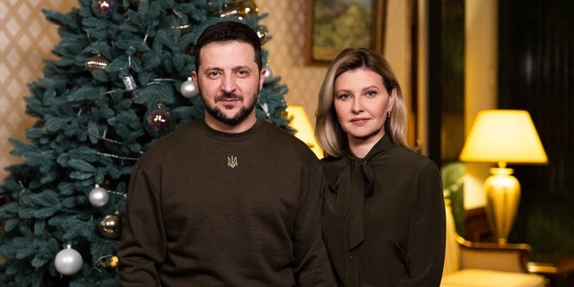 Ukrainian President Volodymyr Zelensky (L) and his wife Olena Zelenska address Ukrainian people on New Year in Kyiv, Ukraine on January 1, 2023. 