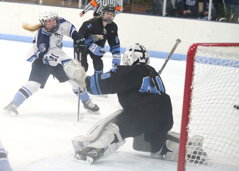 Player in white scores on blue goalie.