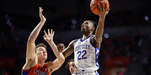 Cason Wallace #22 of the Kentucky Wildcats shoots the ball against Aleks Szymczyk #13 of the Florida Gators during the second half of a game at the Stephen C. O'Connell Center on February 22, 2023, in Gainesville, Florida.