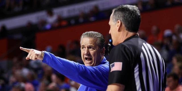 Head coach John Calipari of the Kentucky Wildcats talks to an official during the first half of a game against the Florida Gators at the Stephen C. O'Connell Center on February 22, 2023, in Gainesville, Florida.