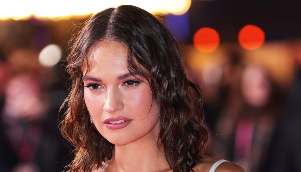 Lily James Oozes Glamour in a Corseted Figure-Hugging Dress and Wet-Look Hair