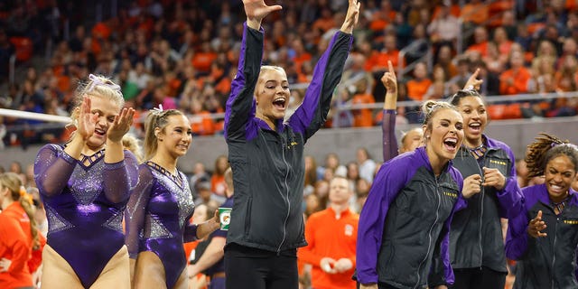 Olivia Dunne of LSU cheers on her teammate during a gymnastics meet against Auburn at Neville Arena on Feb. 10, 2023, in Auburn, Alabama.