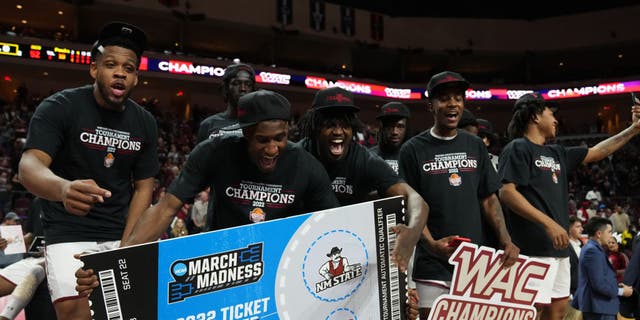 The New Mexico State Aggies celebrate after winning the championship game of the Western Athletic Conference basketball tournament against the Abilene Christian Wildcats at the Orleans Arena on March 12, 2022, in Las Vegas, Nevada.