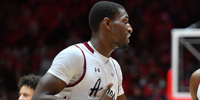 Mike Peake #15 talks to Sir'Jabari Rice #10 of the New Mexico State Aggies during their game against the New Mexico Lobos at The Pit on Dec. 6, 2021 in Albuquerque, N.M.  