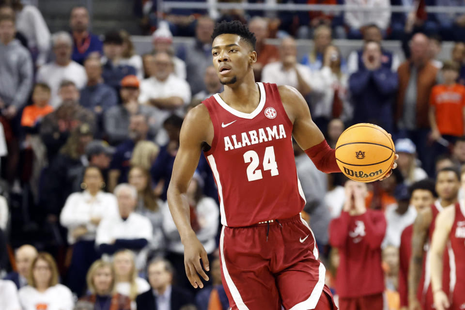 Alabama forward Brandon Miller dribbles the ball during the first half of an NCAA college basketball game against Auburn Saturday, Feb. 11, 2023, in Auburn, Ala. (AP Photo/Butch Dill)