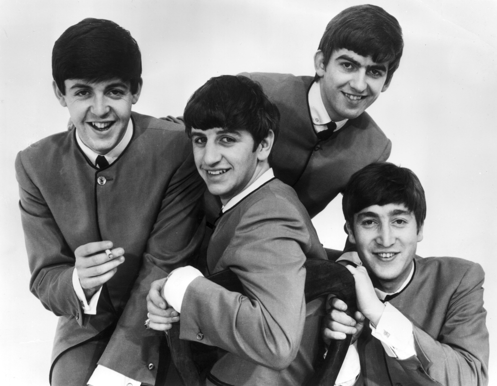 Paul McCartney holds a cigarette, others are (left to right) Ringo Starr, George Harrison (1943 - 2001) and John Lennon