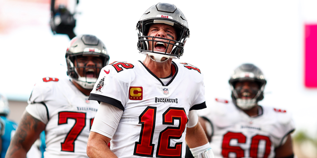 Tom Brady #12 of the Tampa Bay Buccaneers screams in celebration after rushing for a touchdown during the fourth quarter of a game against the Carolina Panthers at Raymond James Stadium on January 1, 2023 in Tampa, Florida.