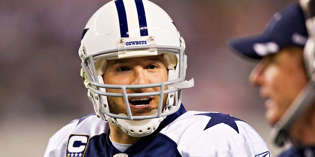 Tony Romo #9 talks with Head Coach Jason Garrett of the Dallas Cowboys during a game against the Miami Dolphins at Cowboys Stadium on November 24, 2011, in Arlington, Texas.