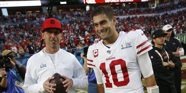 Head Coach Kyle Shanahan and Jimmy Garoppolo #10 of the San Francisco 49ers talk on the field before the game against the Kansas City Chiefs in Super Bowl LIV at Hard Rock Stadium on February 2, 2020 in Miami, Florida. The Chiefs defeated the 49ers 31-20.