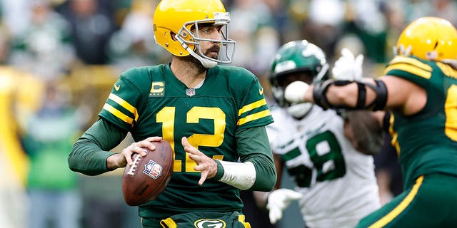 Aaron Rodgers, #12 of the Green Bay Packers, drops back to pass against the New York Jets at Lambeau Field on October 16, 2022, in Green Bay, Wisconsin. The Jets defeated the Packers 27-10. 