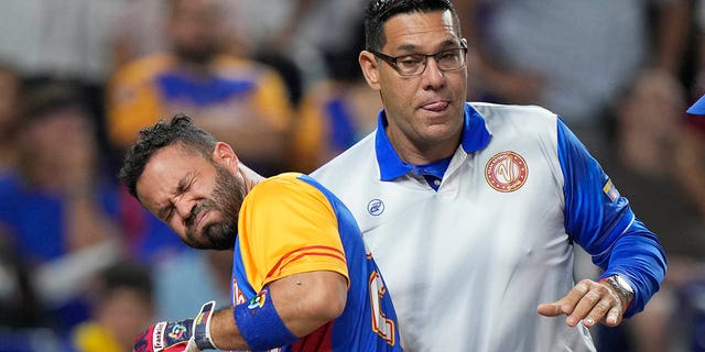 Venezuela's Jose Altuve is helped up by a trainer after he was hit by a pitch during the fifth inning of a World Baseball Classic game against the U.S., Saturday, March 18, 2023, in Miami.