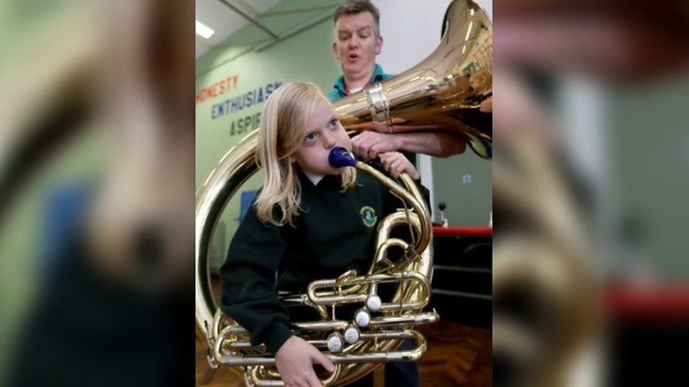 Girl playing a brass instrument