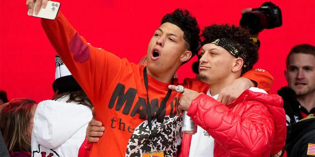 Jackson Mahomes and Patrick Mahomes, #15 of the Kansas City Chiefs, celebrate on stage during the Kansas City Chiefs Super Bowl LVII victory parade on February 15, 2023, in Kansas City, Missouri. 