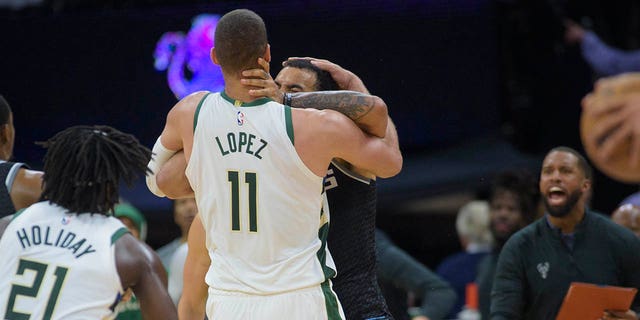 Milwaukee Bucks center Brook Lopez, #11, and Sacramento Kings forward Trey Lyles scuffle in the final seconds of the second half of an NBA basketball game in Sacramento, California, Monday, March 13, 2023.