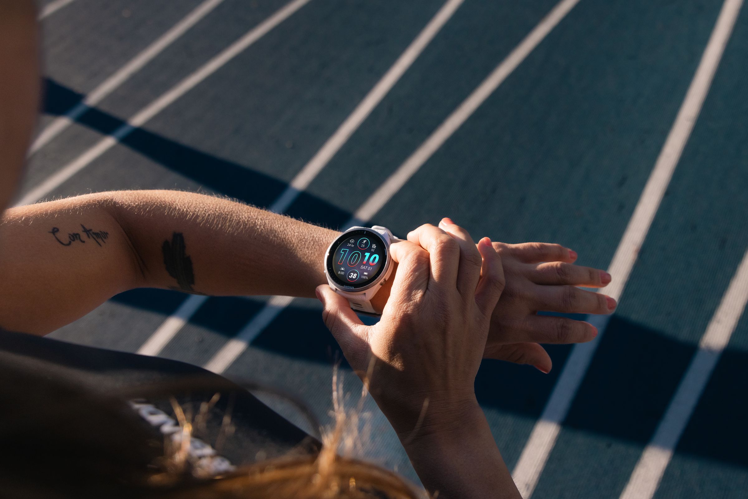 Woman looks at Forerunner 965 on her wrist.