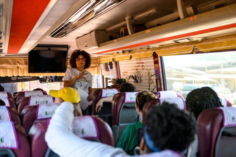 Dr. Vanessa Johnson speaking to people on a bus