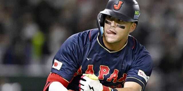 Japan team's Lars Nootbaar gestures during a game against Australia on March 12, 2023, at Tokyo Dome in Tokyo. Nootbaar's pepper-grinder gesture is catching on all across Japan.