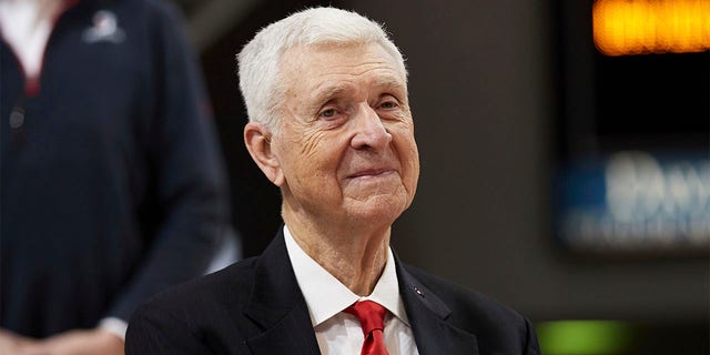 Former Davidson basketball player, coach, and athletic director, and former Virginia coach, Terry Holland, smiles during a ceremony to retire his jersey number 42 following an NCAA college basketball game between LaSalle and Davidson on Sunday, Jan. 30, 2022, in Davidson, North Carolina. Holland, who elevated Virginia basketball to national prominence during 16 seasons as coach and later had a distinguished career as an athletic administrator, has died, the school announced Monday, Feb. 27, 2023. He was 80. 