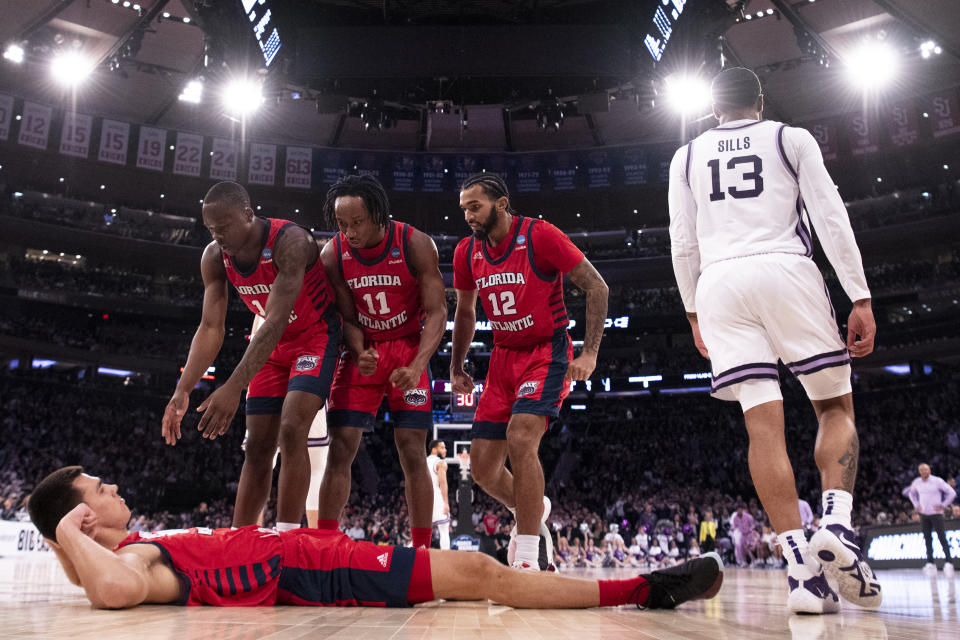 NEW YORK, NEW YORK - MARCH 25: Vladislav Goldin #50 of the Florida Atlantic Owls is helped up by teammates after drawing an offensive foul during the first half of the game against the Kansas State Wildcats during the Elite Eight round of the 2023 NCAA Men&#39;s Basketball Tournament held at Madison Square Garden on March 25, 2023 in New York City. (Photo by Ben Solomon/NCAA Photos via Getty Images)