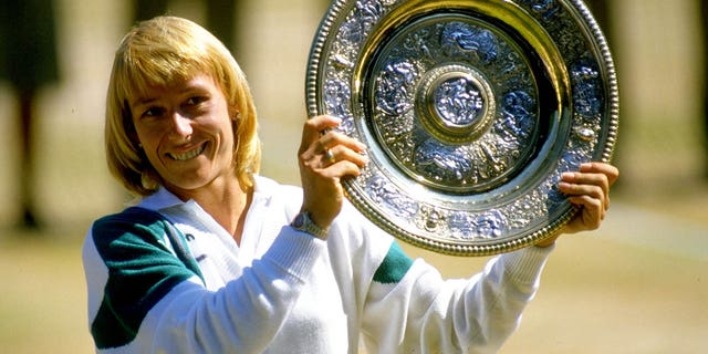 Martina Navratilova holds up the winner plate after winning the Wimbledon Championships played at Wimbledon, London.