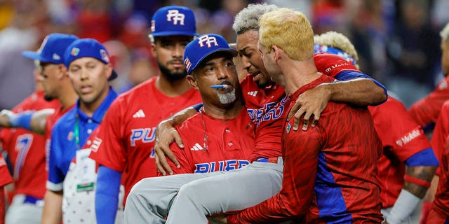 Teammates carry Edwin Diaz off the field after an apparent leg injury at loanDepot park.