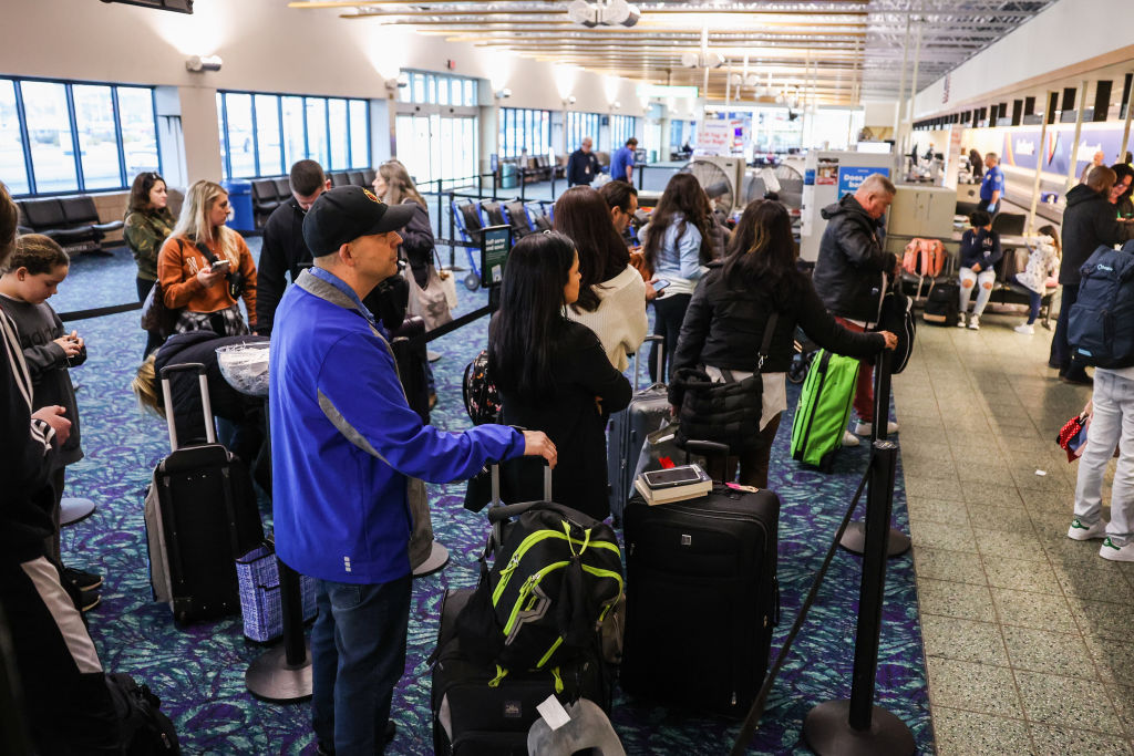 Passengers wait in line for Frontier Airlines flight at Long Island MacArthur Airport