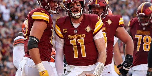 Carson Wentz of the Washington Commanders celebrates after scoring a touchdown against the Cleveland Browns on Jan. 1, 2023, in Landover, Maryland.