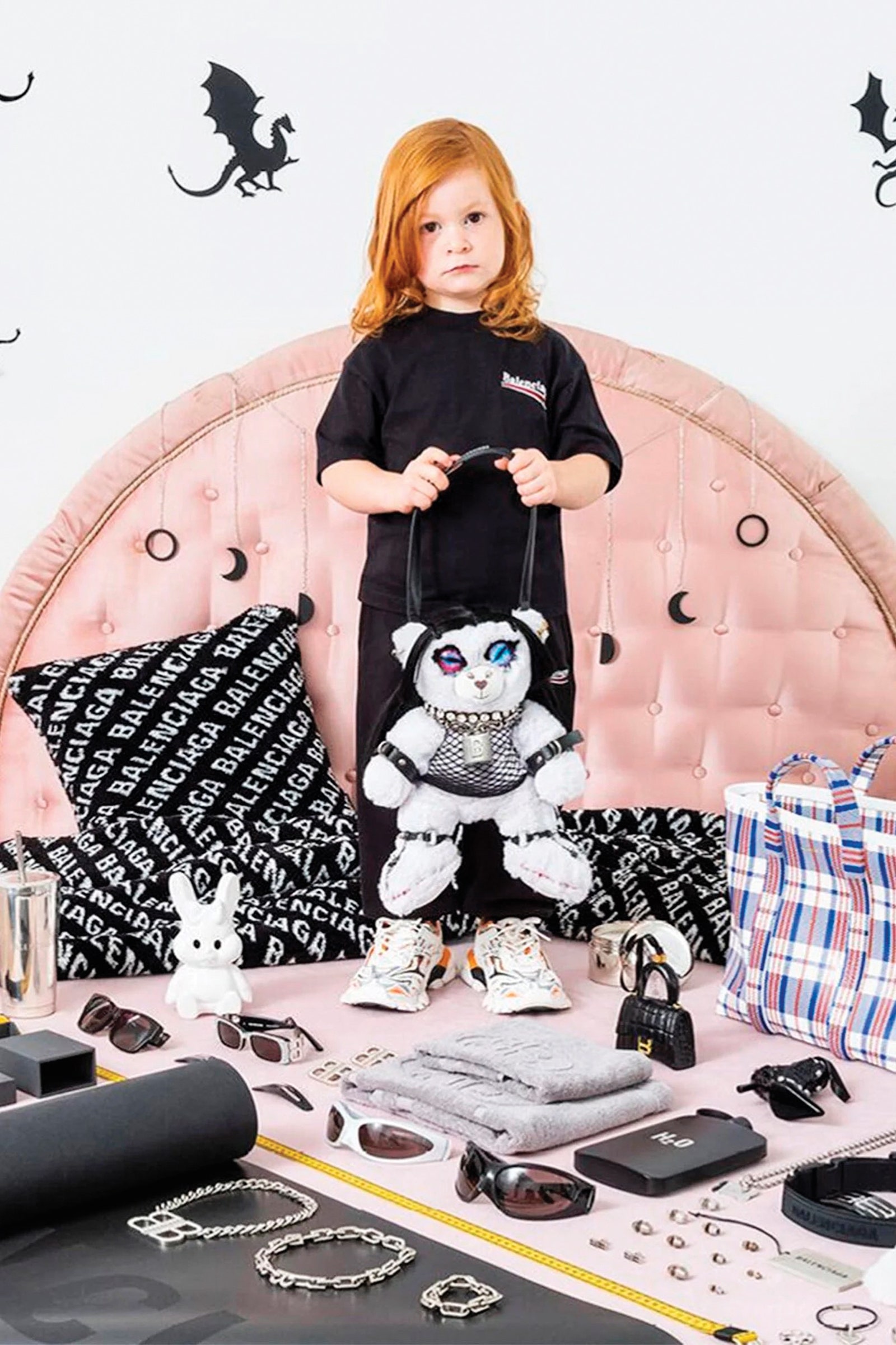 A child stands among Balenciaga merch.