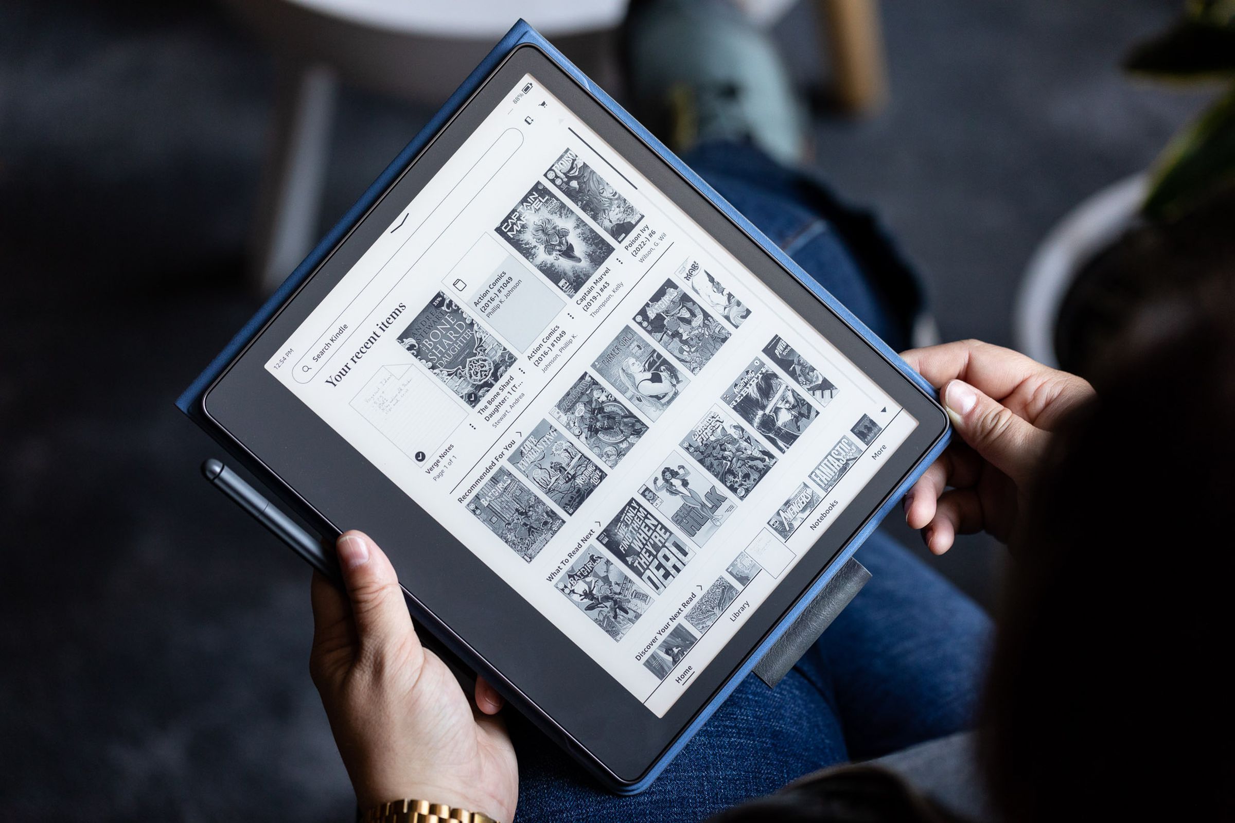 A person holding a Kindle Scribe ebook reader