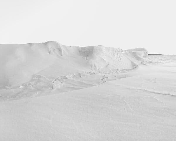 A large, snow-covered glacier extends throughout the frame.