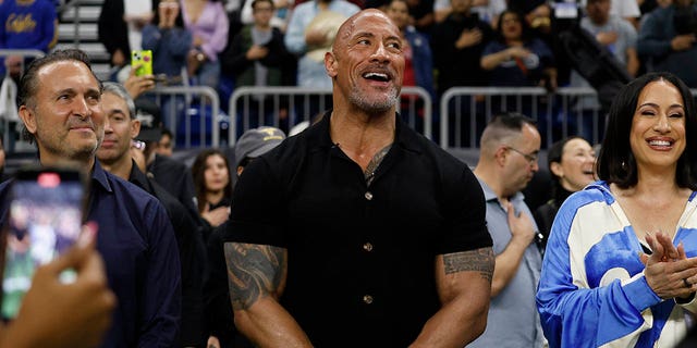 XFL co-owners Gerry Cardinale, Dwayne Johnson and Dany Garcia react before the start of the game between the San Antonio Brahamas and the St. Louis Battlehawks at the Alamodome on Feb. 19, 2023, in San Antonio, Texas.