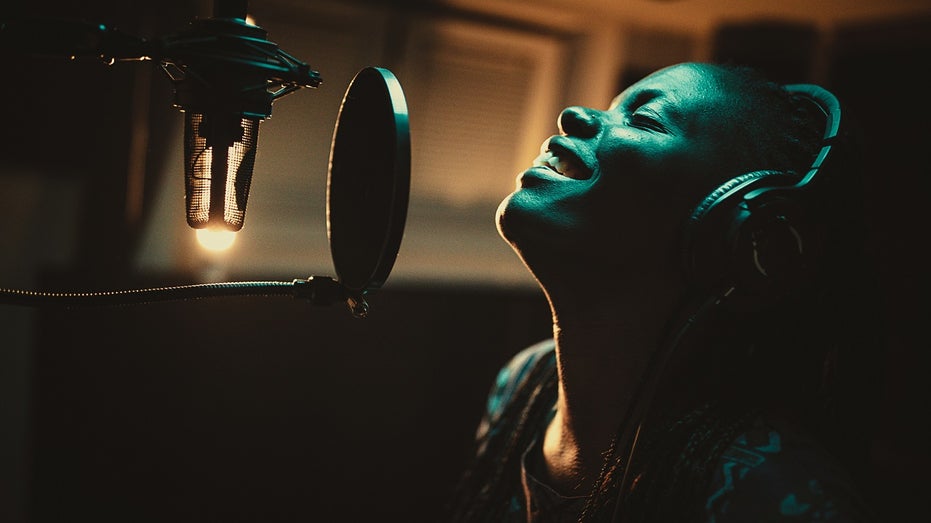 woman sings into microphone