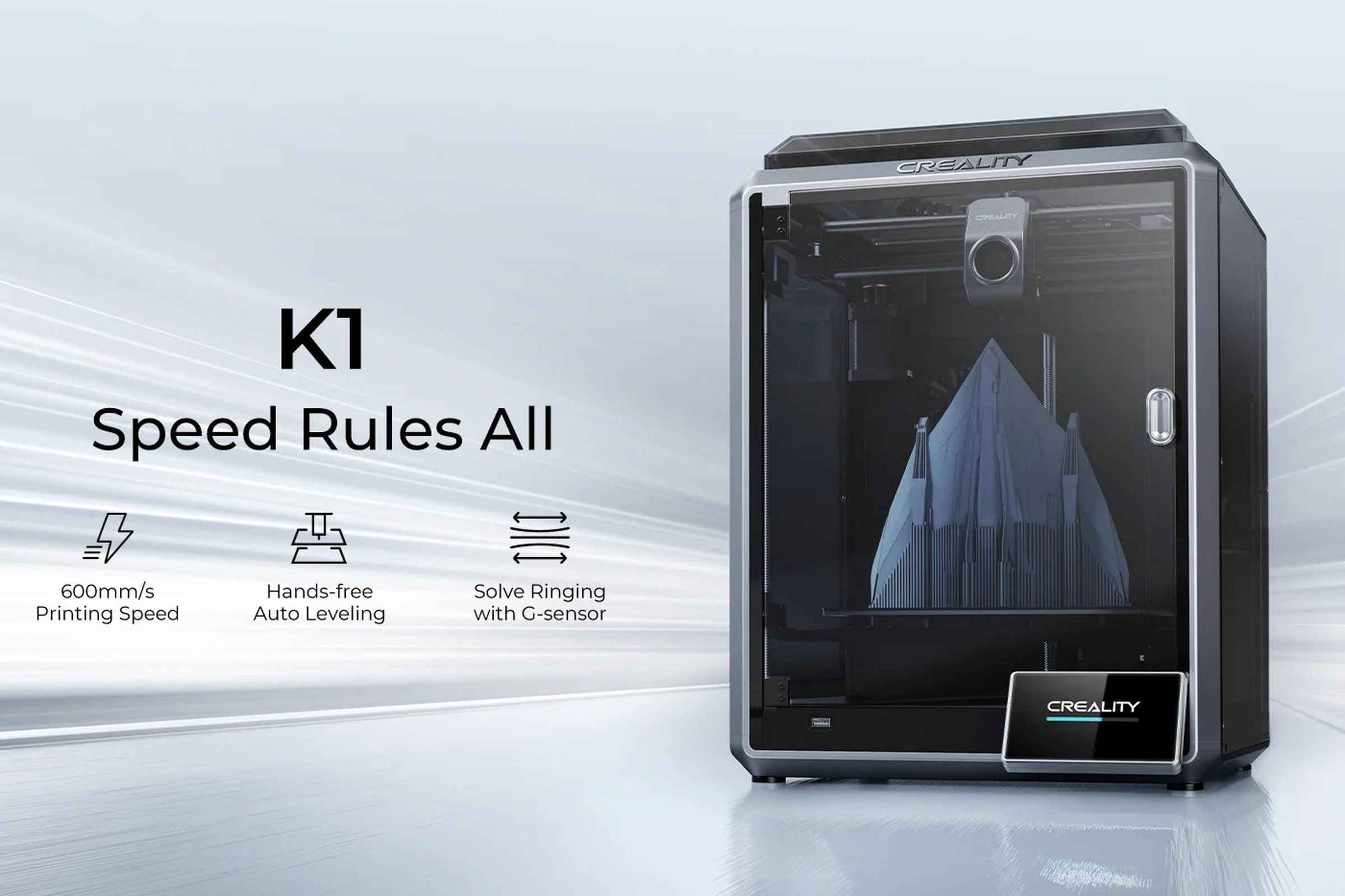 An enclosed box of a 3D printer, with a printed object and a print head on rails with a fan visible inside.