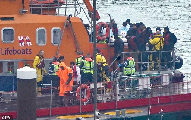 A group of migrants are brought into Dover, Kent, on board a Border Force vessel last Thursday