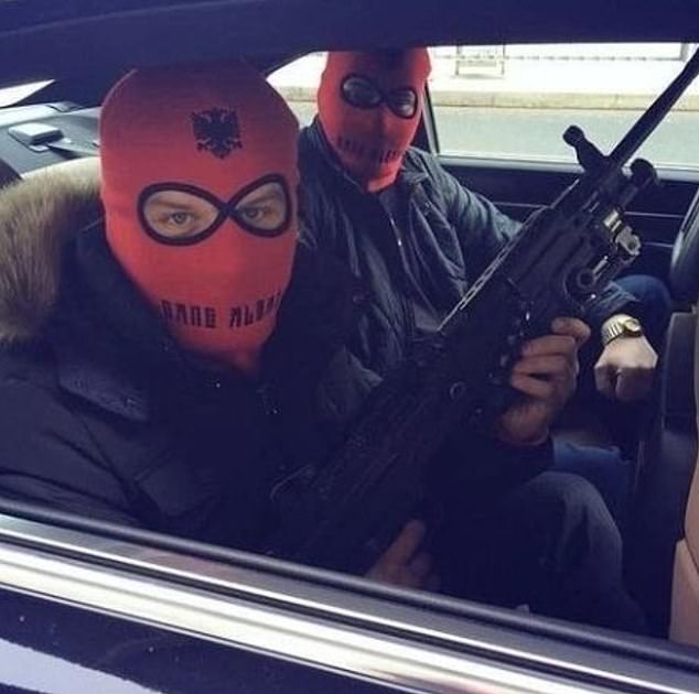 An alleged Hellbanianz member posts a picture of two gang members wearing red balaclavas emblazoned with the Albanian flag, while one brandishes a machine gun